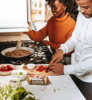 man and woman prepping food together